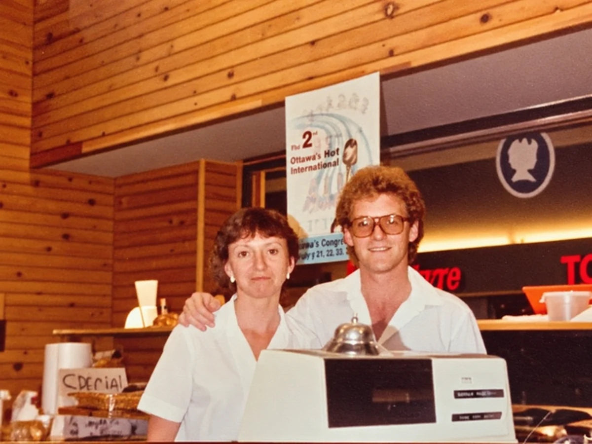 Richard and Rachelle Gagné standing together behind the store counter in 1995